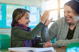 teacher and student high fiving