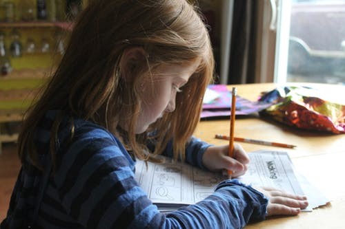 Girl doing homework at the table