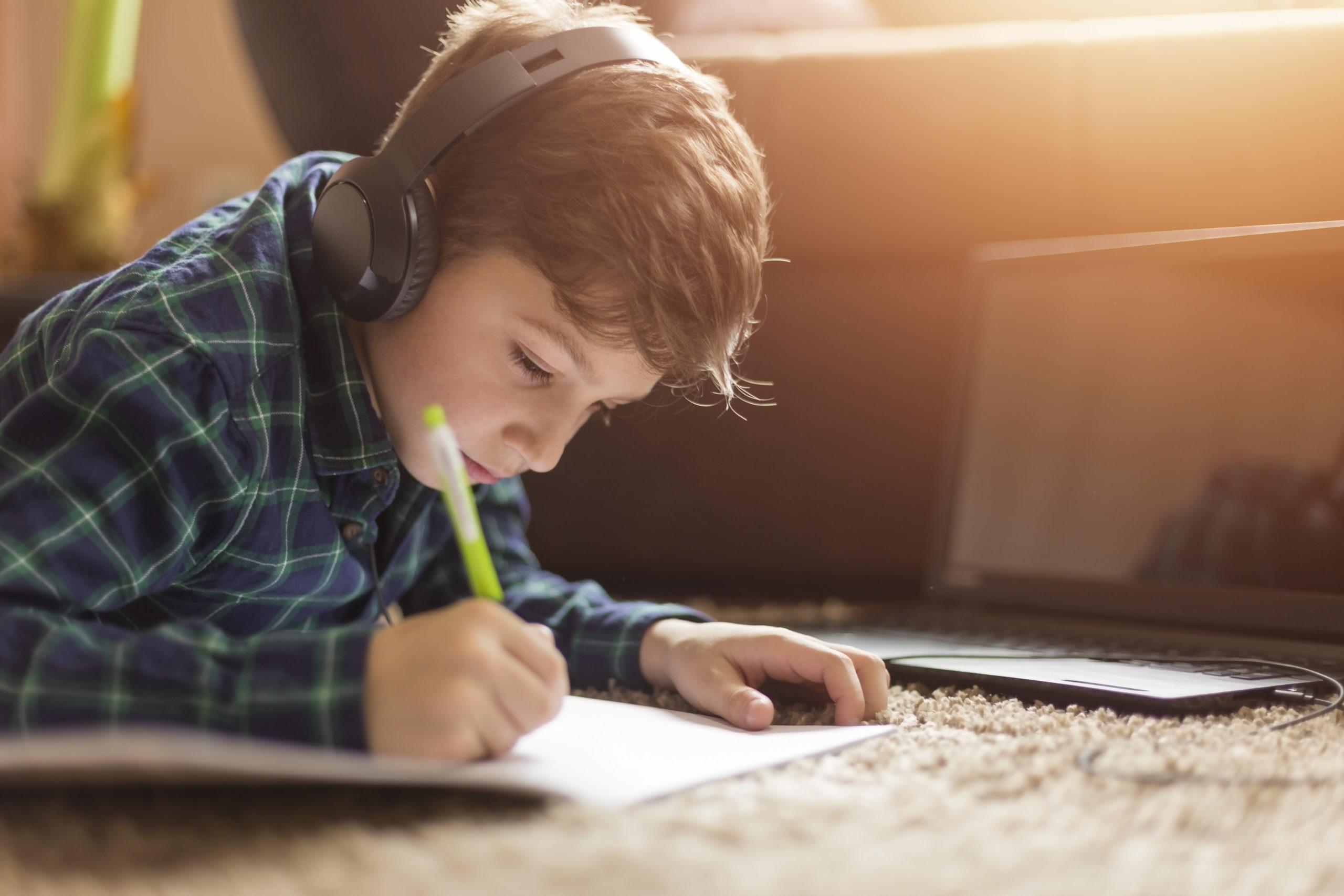 Teenage boy listening to music while doing homework