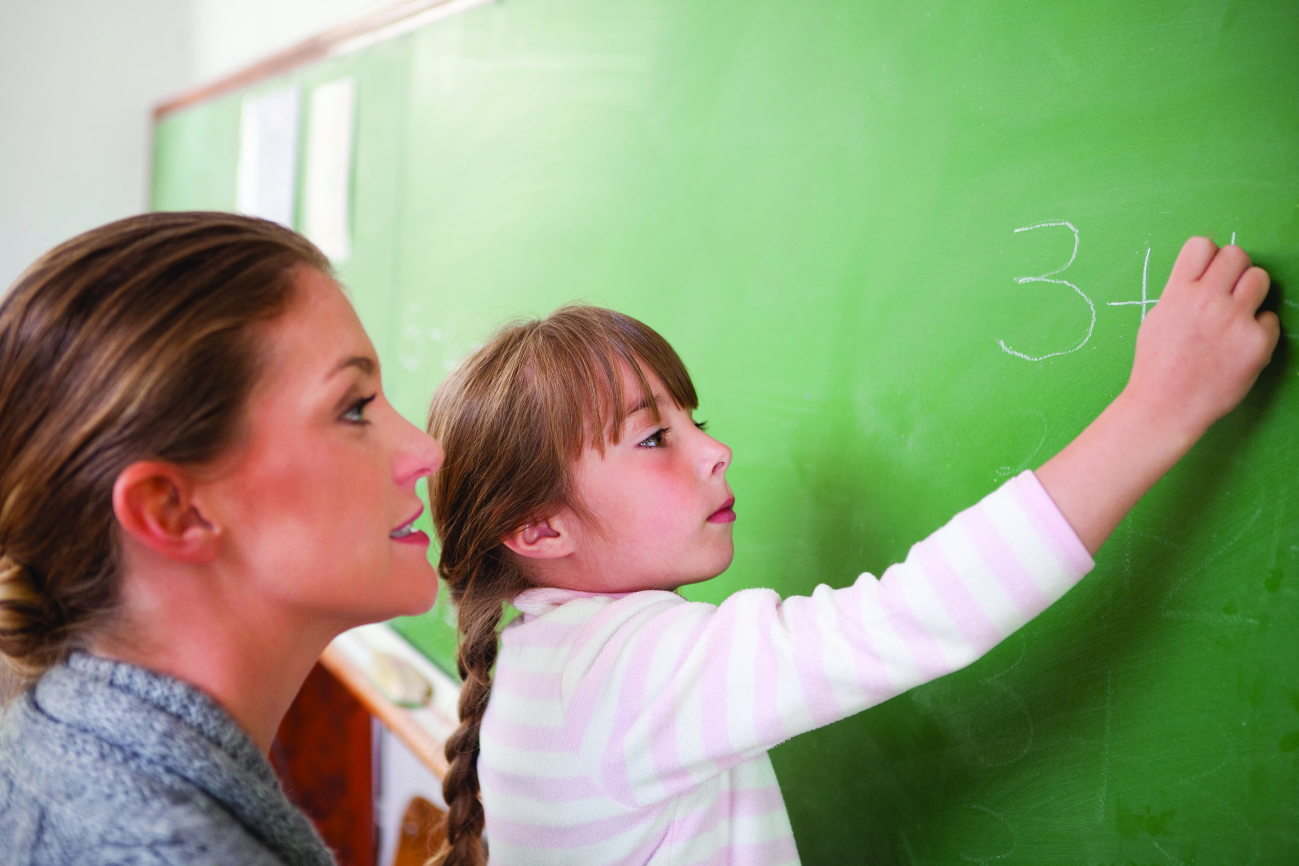 Teacher and a pupil making an addition