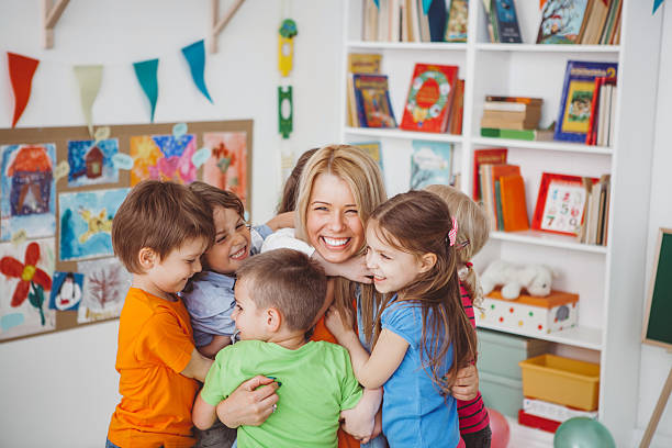 Teacher hugging group of students